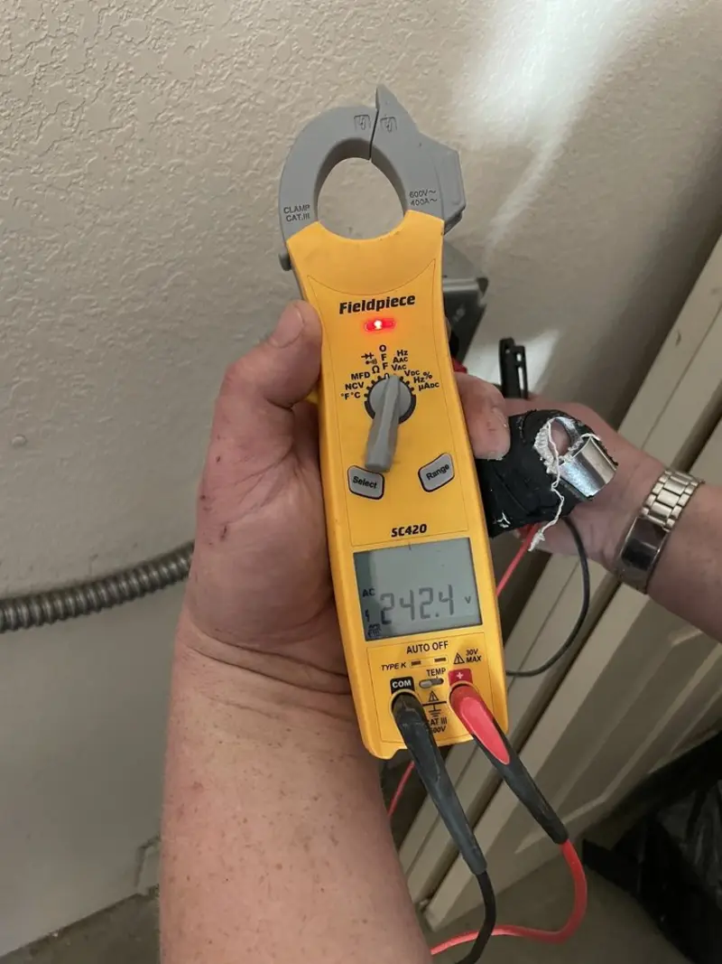 Voltage testing with clamp meter during Recessed Lighting Installation in Manchester
